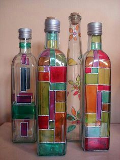 three glass bottles with different designs on them