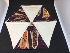 an origami style umbrella with corn on the cob in purple and white