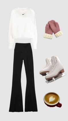 a white sweater, black pants and pink mittens are arranged in front of a cup of coffee