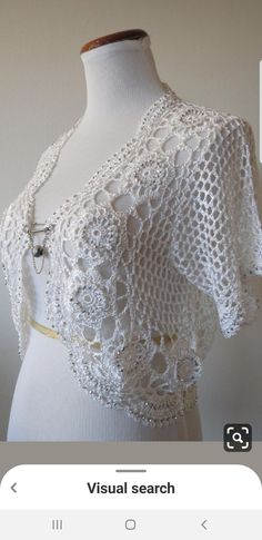 a white crochet top on a mannequin dummy with the words visual search below it