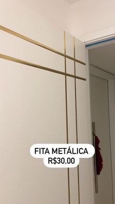 a white wall with gold lines on it and a sticker that says fita metalica $ 350 00