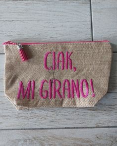 a small purse with the words ciak, mi grano written in pink on it