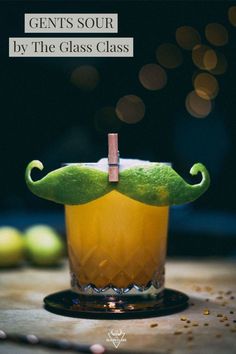 a moustache shaped drink sitting on top of a wooden table