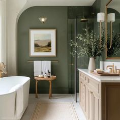 a bath room with a tub a sink and a mirror on the wall in it