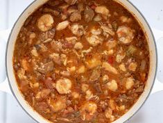 a large pot filled with food sitting on top of a stove