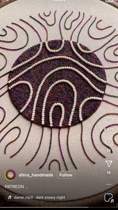 a close up of a piece of art on a cell phone screen with the text, african - handmade follow