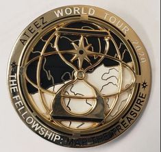 a gold and black medallion with the words world tour on it's center circle