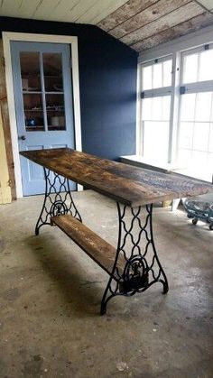 an old table is sitting in the middle of a room next to a blue door