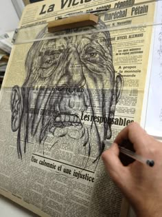 a person is drawing an image on a newspaper