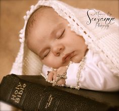 a baby sleeping on top of a book