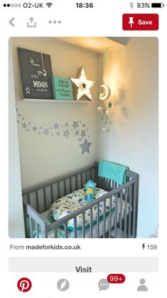 a baby's room with a crib and stars on the wall above it