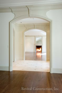 an empty room with a fire place in the center