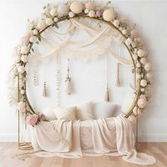 a canopy bed with flowers and tassels on it