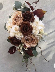 a bridal bouquet with white and brown flowers