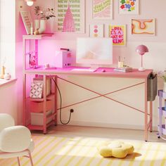 a pink desk and chair in a room with pictures on the wall behind it,