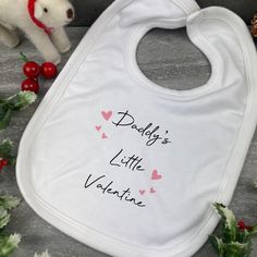 This cute baby bib is the perfect gift for your baby on valentines day! Please select options for mummy or daddy from the drop down list. Each bib has a Velcro fastening and is super soft! The print is dye sublimated into the bib meaning that there will be no peeling off. Cute Pink Bib For Gift, Cute Pink Bib As A Gift, Cute Pink Bib As Gift, Cute Personalized Birthday Bib, Personalized White Bib For Birthday, Cute White Bib For First Birthday, Personalized White Birthday Bib, Customizable White Birthday Bib, Reindeer Dust