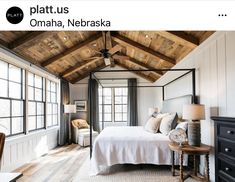 a bedroom with wooden ceilings and white bedding