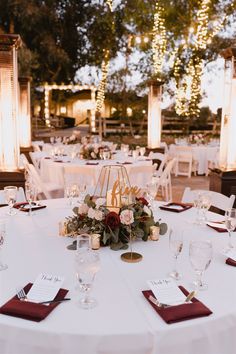 the table is set with white linens and red napkins