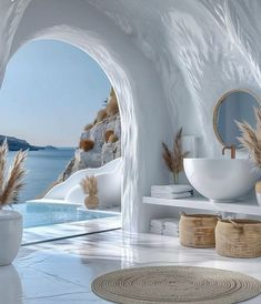 a bathroom with white walls and flooring next to a large window that looks out onto the ocean