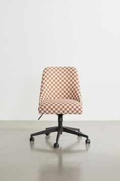 an orange and white checkerboard office chair on casteor wheels with black base