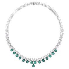 Step into the realm of timeless sophistication with our Pear Zambian Emerald Gemstone Choker Necklace, a pinnacle of luxury and elegance. Crafted with exquisite detail and finesse, this mesmerizing piece is designed to captivate and enchant. Item Code :- SEN-51270 Gross Wt. :- 35.92 gm 18k White Gold Wt. :- 30.75 gm Natural Diamond Wt. :- 12.39 Ct. ( AVERAGE DIAMOND CLARITY SI1-SI2 & COLOR H-I ) Emerald Wt. :- 13.48 Ct. Necklace Length :- 16 Inches Long ✦ Sizing ..................... We can adjust most items to fit your sizing preferences. Most items can be made to any size and length. Please leave a note at checkout or contact us via 1stDibs conversation. Even after purchasing the item, you can still ask us to adjust the size or length. We will try our best to fix it if it is possible. ✦ Gemstone Choker Necklace, Gemstone Choker, Necklace Diamond, Colored Stone, Zambian Emerald, Emerald Necklace, Large Gift, Antique Necklace, White Gold Jewelry