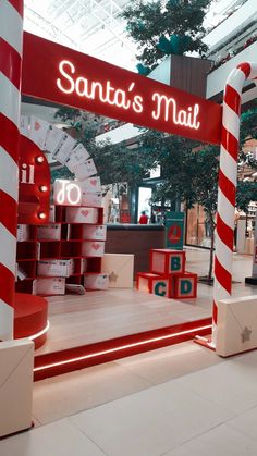 the entrance to santa's mail is decorated with red and white striped pillars, which are stacked on top of each other