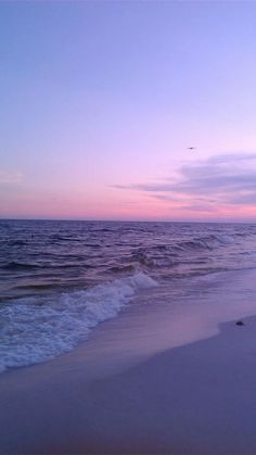 an ocean beach with waves coming in to shore