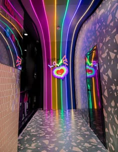 a brightly lit hallway with colorful neon lights