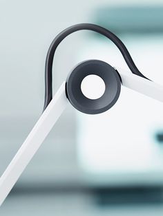 a white and black headphone sitting on top of a table