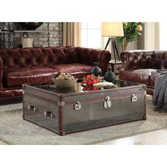 a living room filled with furniture and a brown leather couch next to a coffee table