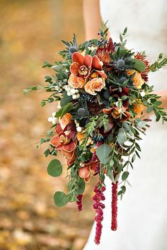 a bridal holding a bouquet of flowers and greenery