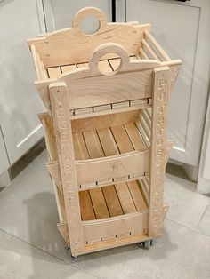 a wooden cart sitting on top of a kitchen floor