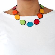 "This beautiful design consists of 13 tagua chips (with rind on the edges) that are linked with cotton cord knots. It is 20 inches long from tip to tip, and adjustable. All the beads used are sustainable, organic, and vegan, pure vegetable ivory (Tagua seeds). *This multicolor tagua necklace is handmade and fair trade *Lightweight and adjustable tagua necklace *Makes the perfect gift for any occasion, thoughtful and unique :) *Materials used: tagua seeds and cotton cord *Naturally eco friendly tagua necklace Production Method: When ripe, tagua seeds are harvested and dried for 6 to 9 months. After losing all their moisture they become rock solid resembling ivory in color, texture, and hardness, hence their nickname: \"Vegetable Ivory\". At this point the hard seeds can be polished, dyed, c Marimo Moss Ball Terrarium, Godchild Gift, Tagua Necklace, Wedding Flip Flops, Anniversary Ornament, Goddaughter Gifts, Tagua Nuts, First Communion Gifts, Natural Jewelry