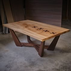 a wooden table with crosses on it in a garage area next to other woodworking supplies