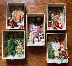 four boxes with christmas ornaments in them on a table