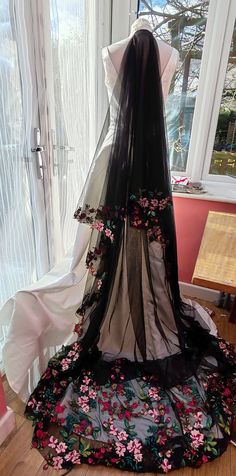 a wedding dress on display in front of a window