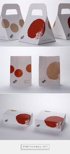 three different boxes with red and brown designs on the front, one in white and one in orange