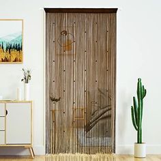 a living room with a sliding glass door in the center and a potted plant on the side