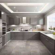 a modern kitchen with grey cabinets and white counter tops, along with an island in the middle