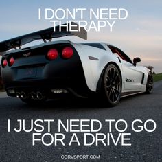 a white sports car driving down a road with the words i don't need therapy