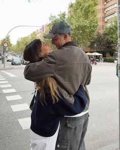 a man and woman hugging on the street