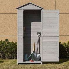 an outhouse with shovels and gardening tools in it