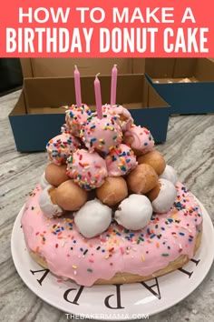 a birthday donut cake with pink frosting and sprinkles on top