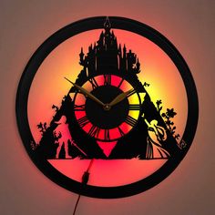 a clock that is lit up with the silhouette of a castle on it's face