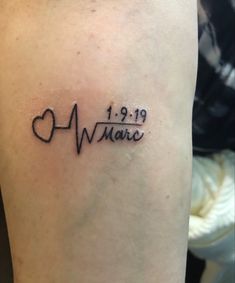 a small tattoo on the leg of a person with a heart and heartbeat in it