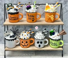 halloween themed coffee mugs are on display