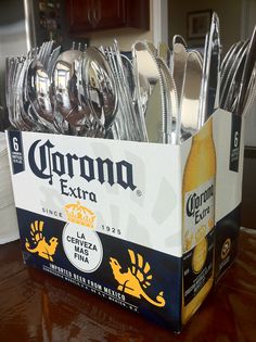 a box filled with silverware sitting on top of a wooden table