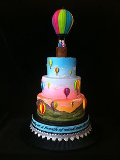 a multi layer cake with hot air balloons on top