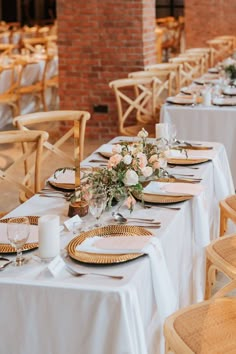 the tables are set with white and gold place settings