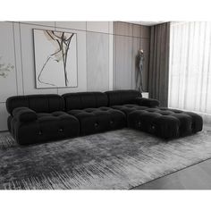 a large black couch sitting on top of a rug